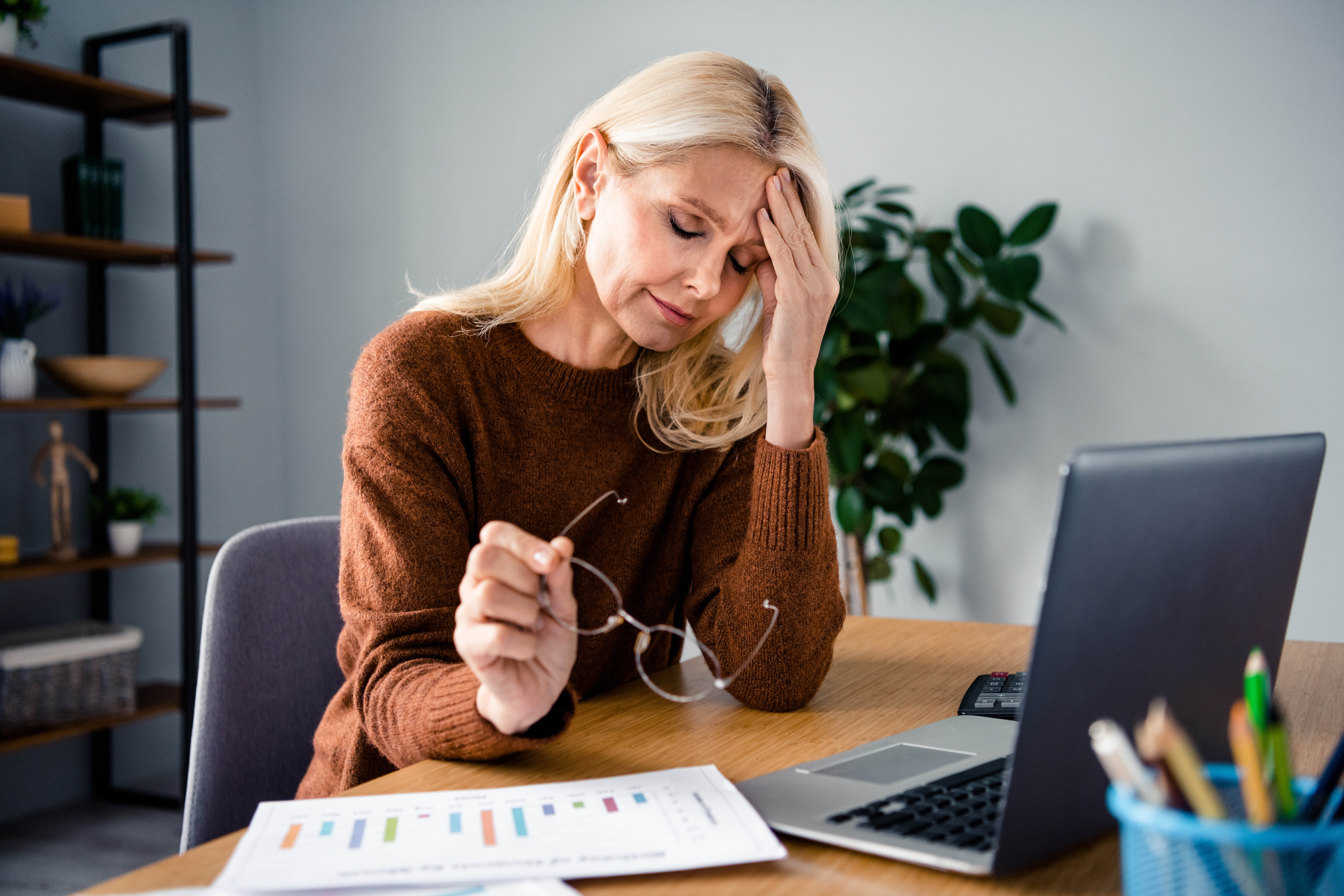Older woman looking stressed at her computer Older woman looking stressed at her computer